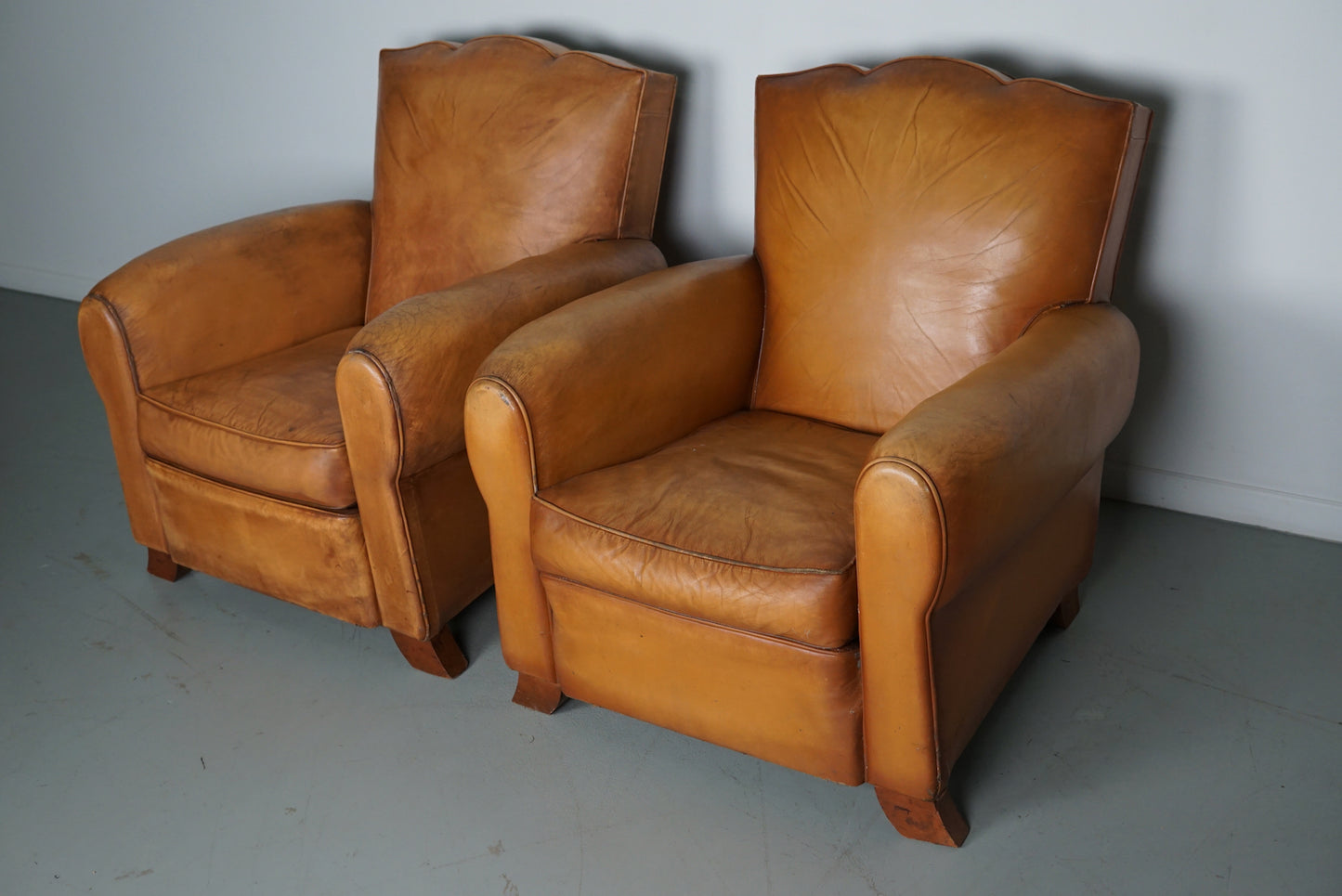 Pair of French Cognac Moustache Back Leather Club Chairs, 1950s
