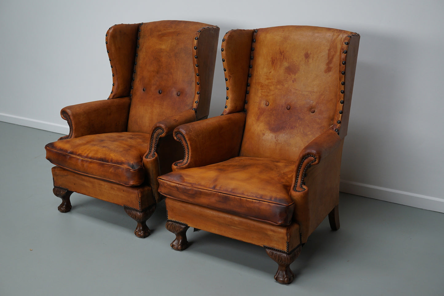 Pair of Patinated Dutch Wingback Cognac Colored Leather Club Chairs