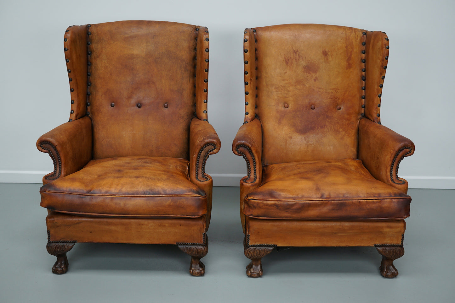 Pair of Patinated Dutch Wingback Cognac Colored Leather Club Chairs