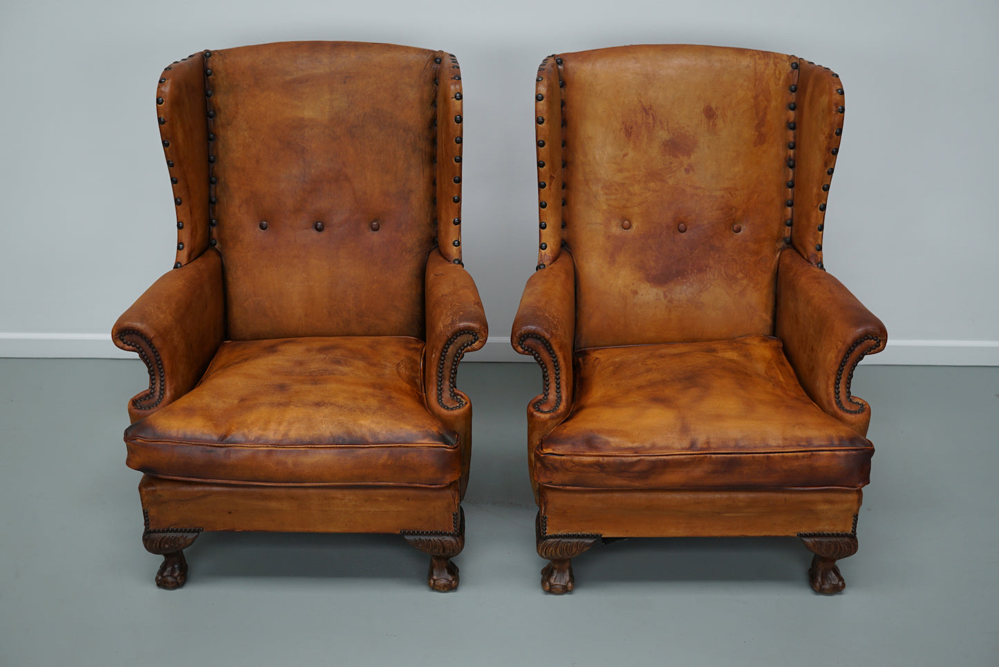 Pair of Patinated Dutch Wingback Cognac Colored Leather Club Chairs
