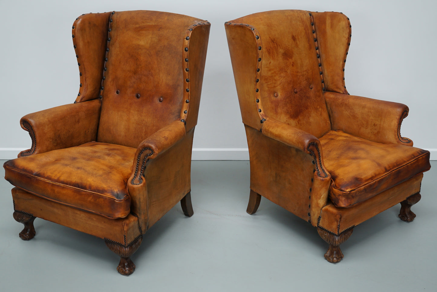Pair of Patinated Dutch Wingback Cognac Colored Leather Club Chairs