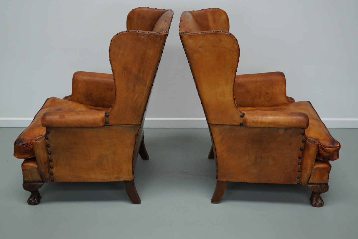 Pair of Patinated Dutch Wingback Cognac Colored Leather Club Chairs