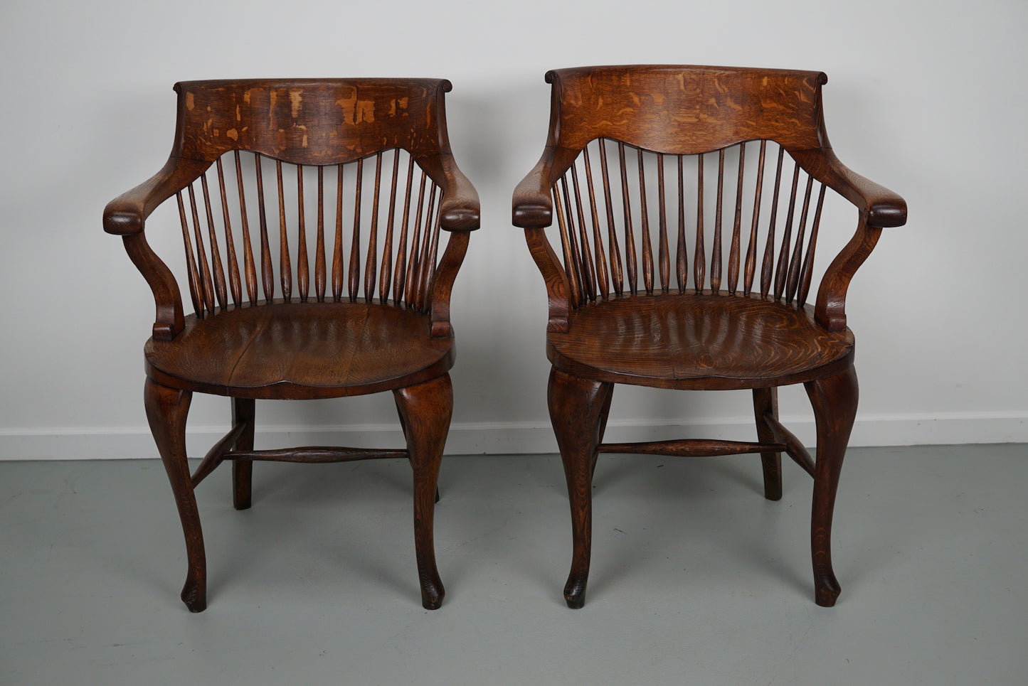 Pair of English Edwardian Oak Spindle Back Captains Office Desk Chairs