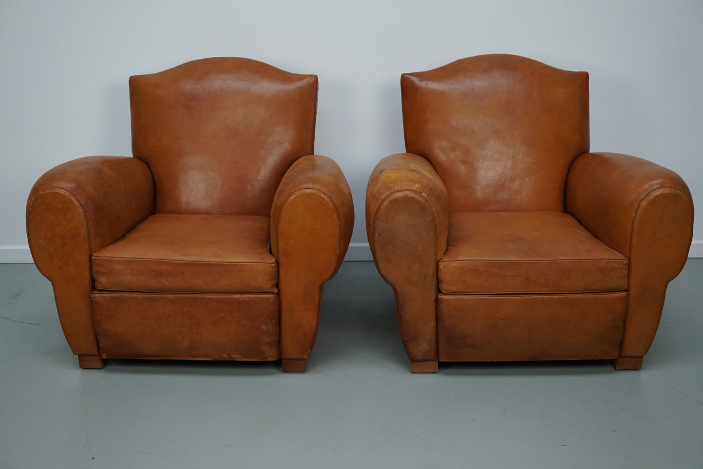 Pair of French Cognac Moustache Back Leather Club Chairs, 1950s