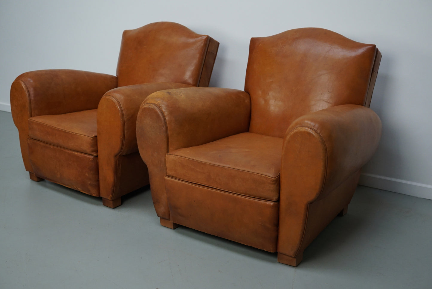 Pair of French Cognac Moustache Back Leather Club Chairs, 1950s
