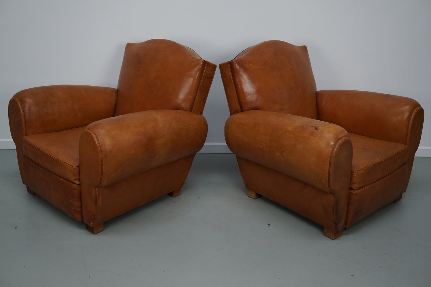 Pair of French Cognac Moustache Back Leather Club Chairs, 1950s