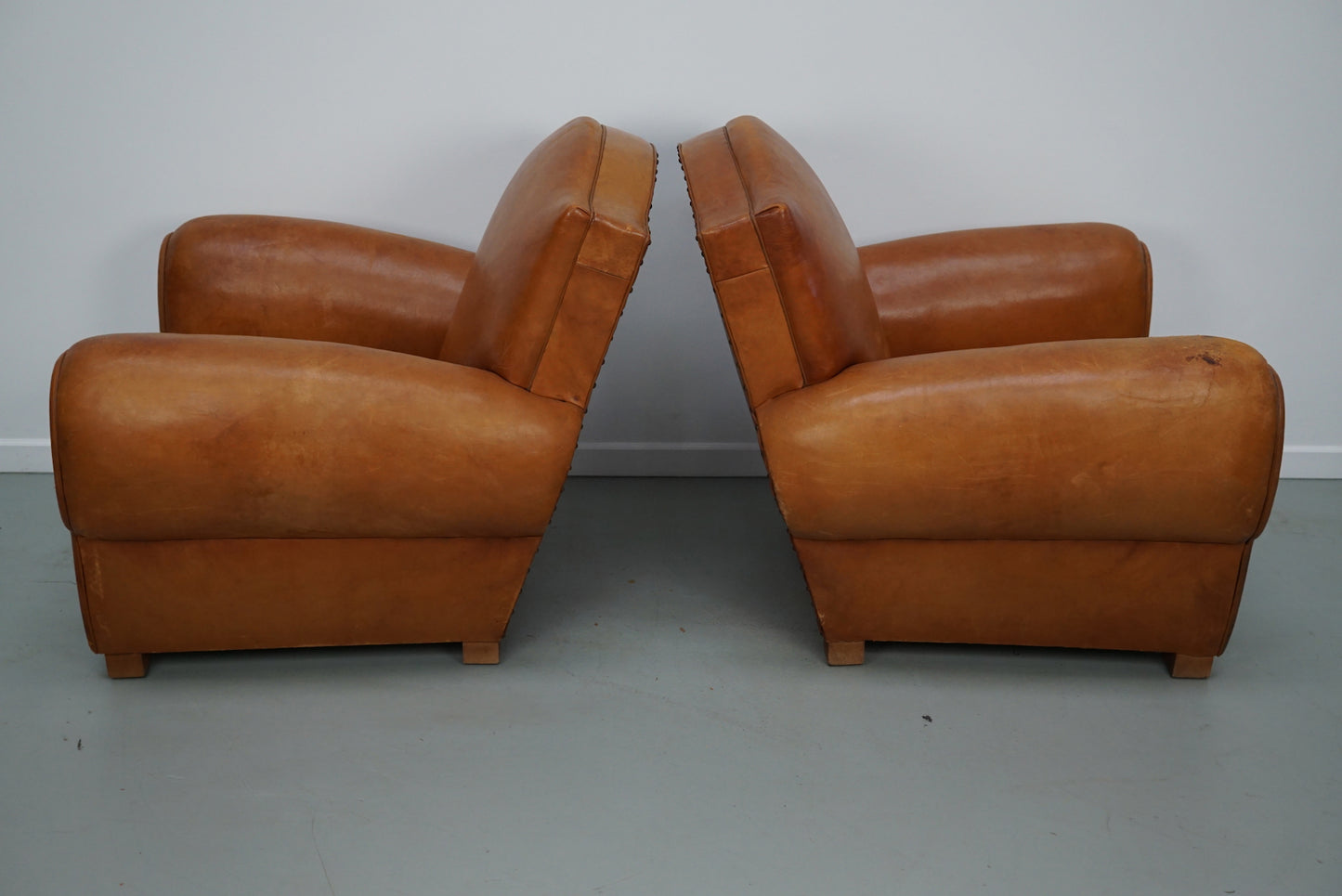 Pair of French Cognac Moustache Back Leather Club Chairs, 1950s