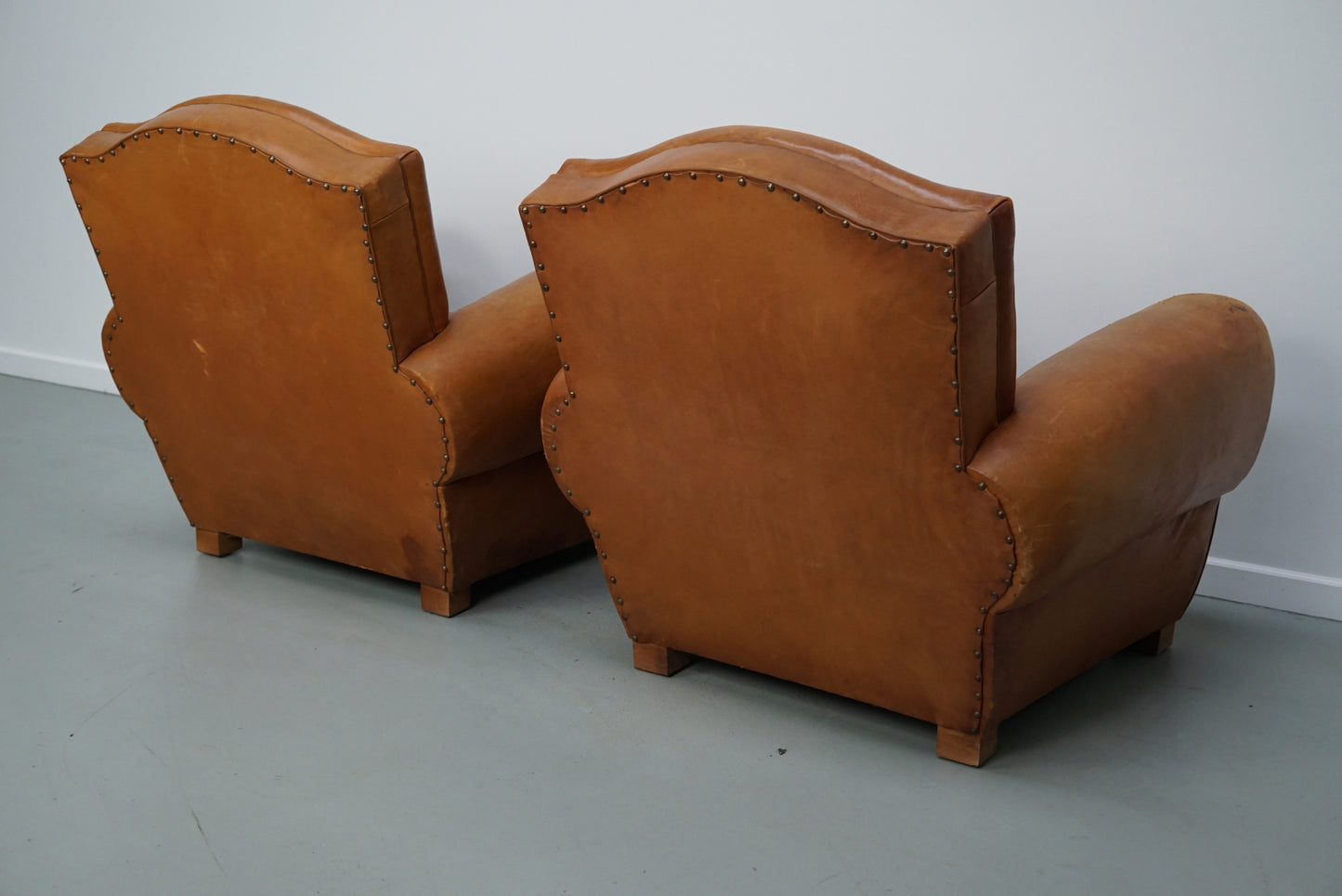 Pair of French Cognac Moustache Back Leather Club Chairs, 1950s