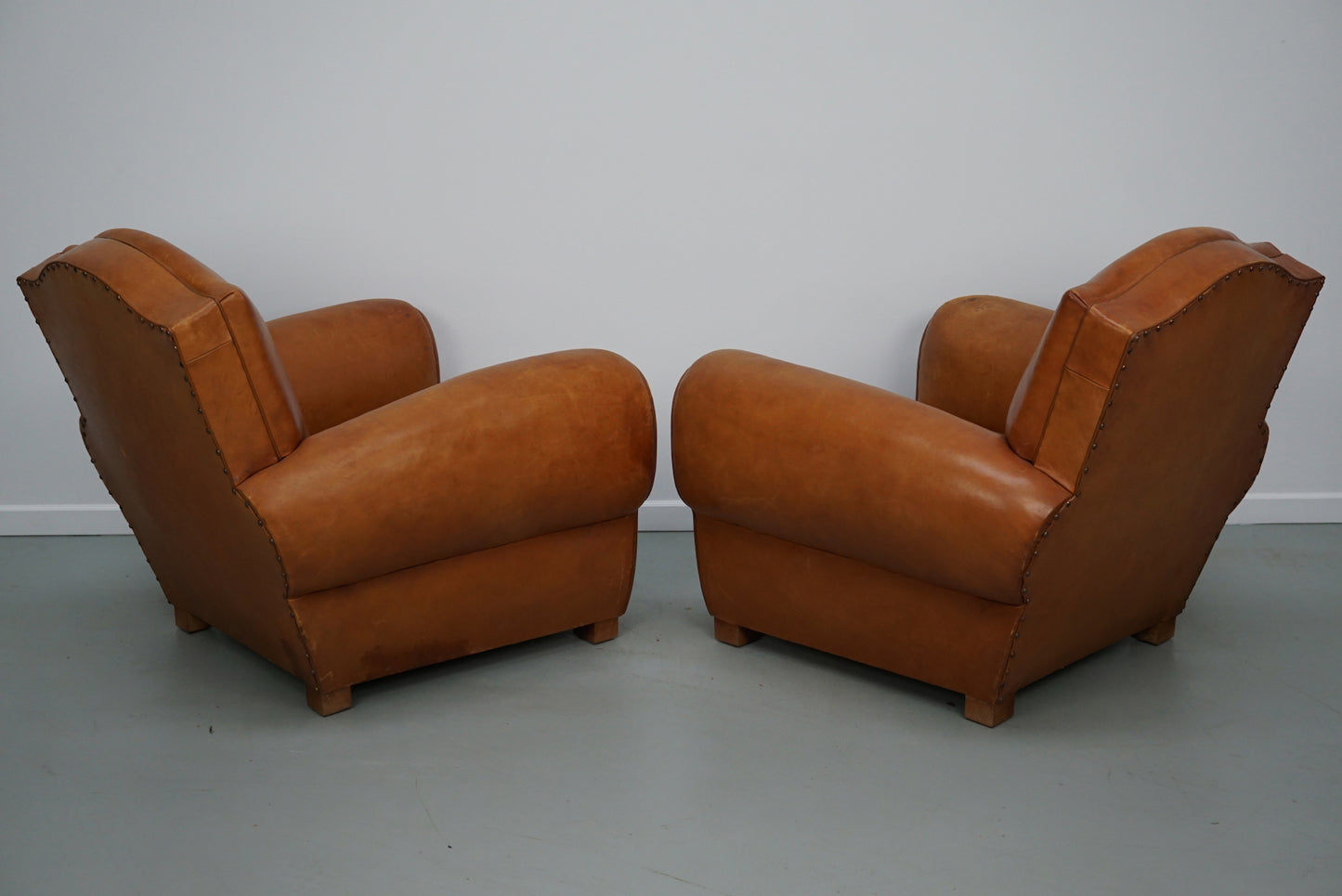 Pair of French Cognac Moustache Back Leather Club Chairs, 1950s