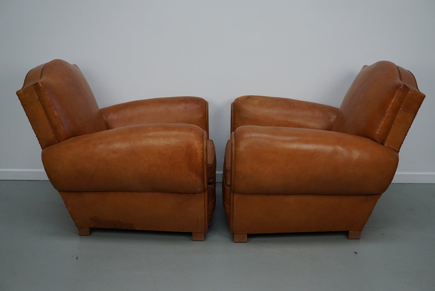 Pair of French Cognac Moustache Back Leather Club Chairs, 1950s